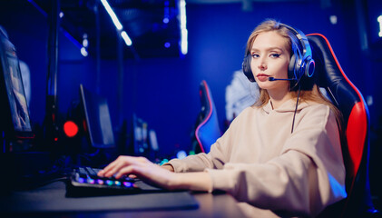 Banner young woman happy pro gamer having live stream and playing in online video game to subscribers, blue neon color