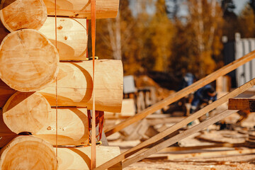 Timber building house construction circle log with blue sky sun light