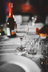 table in a restaurant with white tablecloth and empty glasses