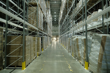 Huge distribution warehouse with high shelves and loaders. Bottom view.