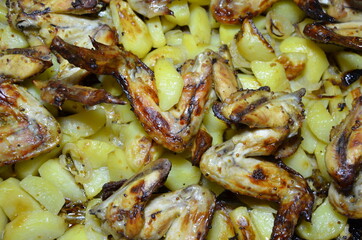 grilled chicken wings close-up. fried chicken with potatoes.