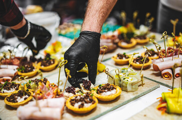 Chef hand is in process of Preparing catering food