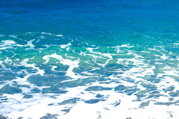 Fototapeta na wymiar Blue, white, turquoise waves in the sea in Sicily