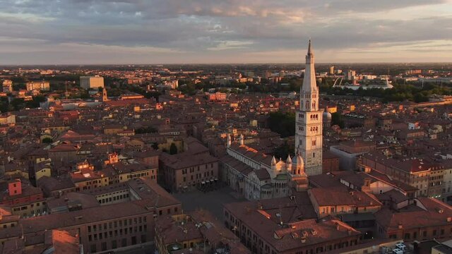 modena city center and cathedral aerial view drone,flying orbit over grande square cathedral and ghirlandina tower at sunrise