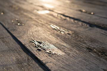 The wooden deck reflects the sunlight at sunset. Diagonal