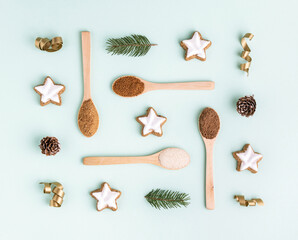 Christmas holiday flat lay pattern with cinnamon ginger cookies and wooden spoons with organic...