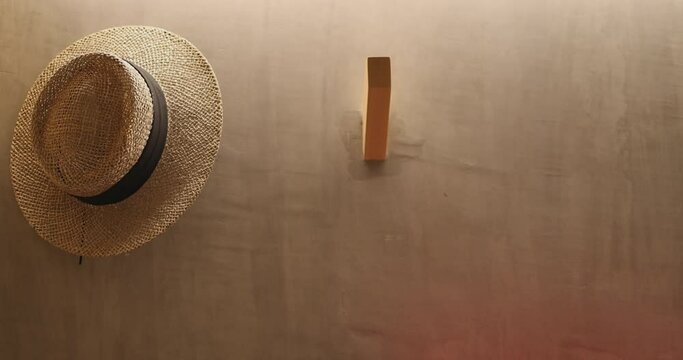 4K Close up slow motion hand take the hat from the wall. Concept of lifestyle and vacation.