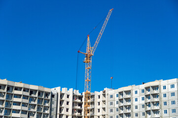 Fototapeta na wymiar Construction cranes and construction of multistorey building