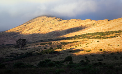 Beautiful sunrise landscape scenery with mountains illuminated with morning light at Aesleagh in county Mayo, Ireland 