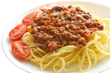 Spaghetti Bolognese with minced beef, onion, chopped tomato, garlic, olive oil, stock cube, tomato puree and Italian herb. Traditional Italian food on a white plate.