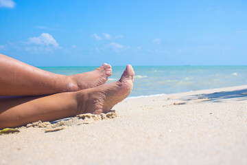 close-up foot vacation relax on the beach sunbathe enjoying the sun on a sunny summer day.