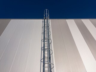 Naklejka premium Metal staircase with safety railing made of steel for a roof maintenance