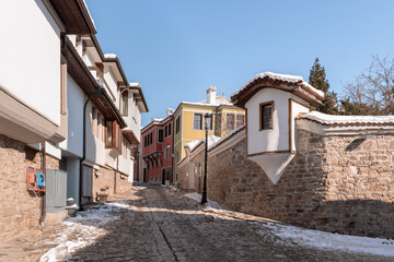 Fototapeta na wymiar Snow on street of Old Town in Plovdiv, Bulgaria on winter, clear sunny day.