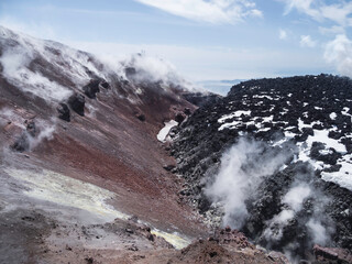 Silhouettes of men hiking at caldera of Avachinsky stratovolcano, also known as Avacha Volcano....