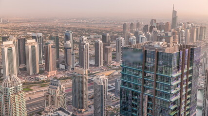 Fototapeta na wymiar Dubai Marina and JLT district with traffic on highway between skyscrapers aerial timelapse.