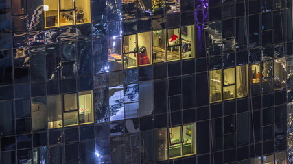 Light in windows of modern towers. Exterior of apartment building at night with glowing windows timelapse.