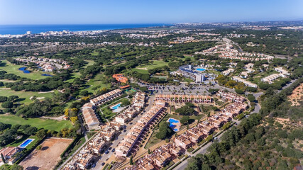 Fototapeta na wymiar Aerial drone footage of a Portuguese tourist village overlooking the sea and golf courses. Vila Sol