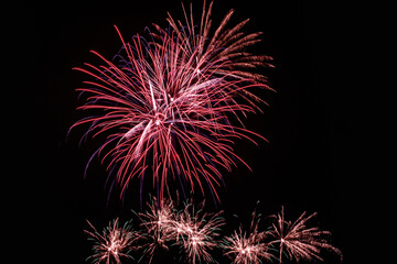 Colorful fireworks lights on the sky background at night