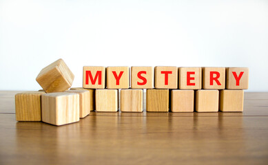 Mystery symbol. The concept word Mystery on wooden cubes. Beautiful wooden table, white background, copy space. Business and mystery mysterious concept.