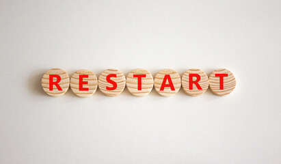 Restart and start symbol. The concept word Restart on wooden circles. Beautiful white background, copy space. Business restart and start concept.