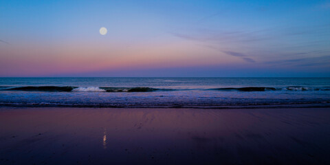 Obraz premium Moonrise seascape and wet sand reflections at Cape Cod National Seashore, 40 miles long pristine sandy beach, hills, and trails.
