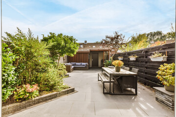 Amazing courtyard design with wooden bench and lots of greenery - obrazy, fototapety, plakaty