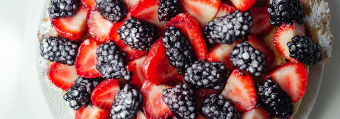 Butter enriched shortcrust pastry topped strawberries and blackberries, seasonal cake with colorful...