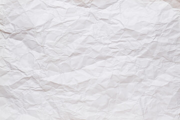 Crumpled, straightened sheet of white paper. Textured background. Copy space. Top view. 