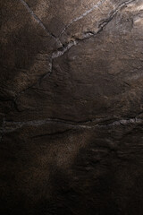 Brown textured clay wall design with cracks and imperfections. Wall design ideas in contemporary interior.