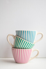 Beautiful set of striped cups on a white background