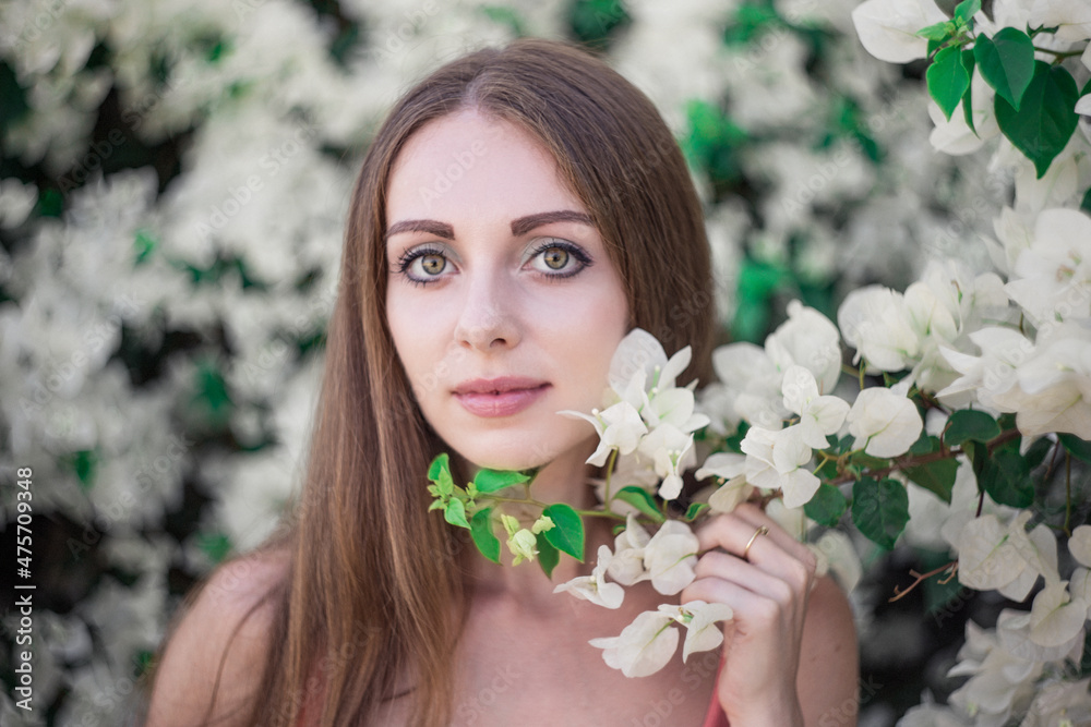 Sticker young smiling caucasian female next to flowers