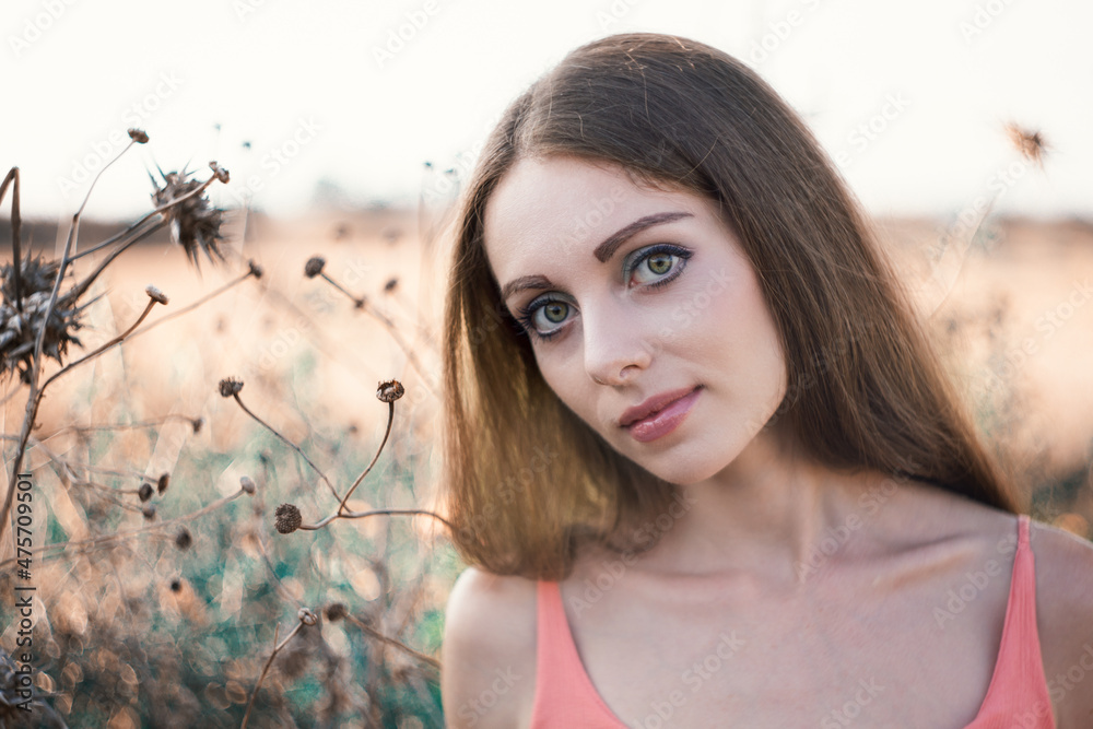 Wall mural Pretty Caucasian woman with long hair posing in the field