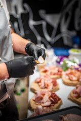 Chef hand is in process of Preparing catering food