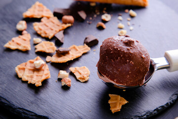 A scoop of chocolate ice cream on a dark background