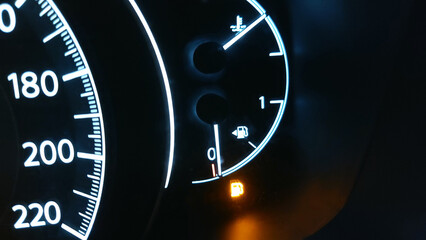 the fuel level icon is lit on the dashboard in the car