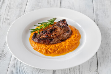 Beef steak with mashed pumpkin