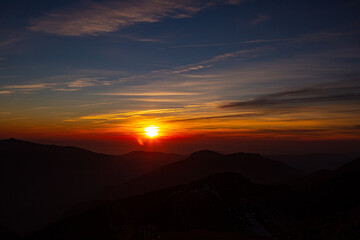 Fantastic views in the mountains during sunset with the silhouette of the peak