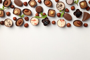 Flat lay composition with chocolate candies on white background