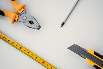Repair work tools lie on white isolated background, place for text