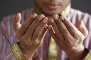 muslim man keep hand in praying gestures during ramadan, Close up 