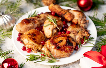 Different parts of Christmas turkey baked with cranberries and rosemary on a stone background. Delicious festive food for Christmas.