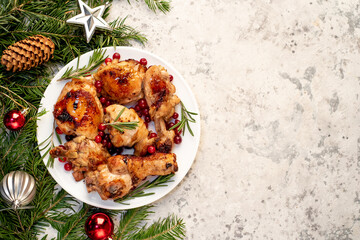 Various pieces of Christmas turkey baked with cranberries and rosemary on a stone background, with copy space for your text. Delicious holiday food for Christmas.