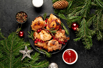 Different parts of Christmas turkey baked with cranberries and rosemary on a stone background. Delicious festive food for Christmas.