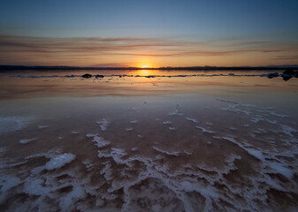 Sunset on the pink lagoon of the salt flats of Torrevieja, Spain