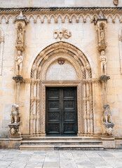 Fototapeta na wymiar The northern portal of the St. James cathedral in Sibenik city. The St. James cathedral is one of main sights of Shibenik. The portal is called the Lion Gate.