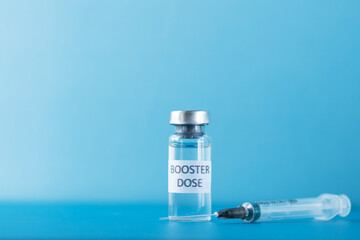 booster dose of coronavirus vaccine on a blue background,revaccination, protection against infection with covid-19