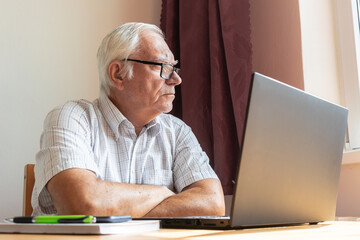 senior old man male sit next at desk, home office online notebook laptop work business distance freelancer