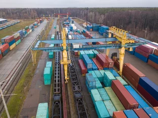Rolgordijnen Multicolored freight containers at the railway customs. Aerial drone view. © Sergey