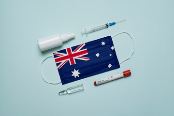 Blood tube for test detection of virus Covid-19 Omicron Variant with positive result, medicine mask with Australia flag superimposed and vaccine.  New Variant of the Covid-19 Omicron