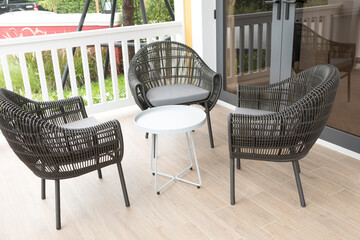 Three Wicker chairs and table on the outdoor terrace